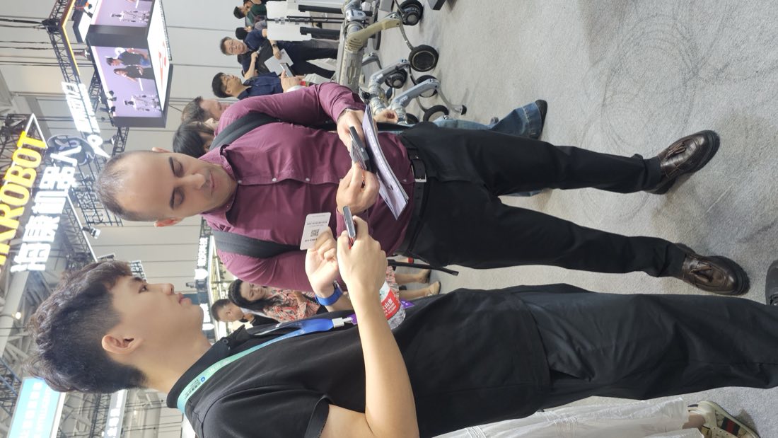 Rachid Atouli exchanging contacts with a manufacturer representative at WRC 2026